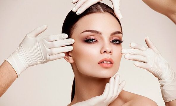 Hand in gloves on the girl's face
