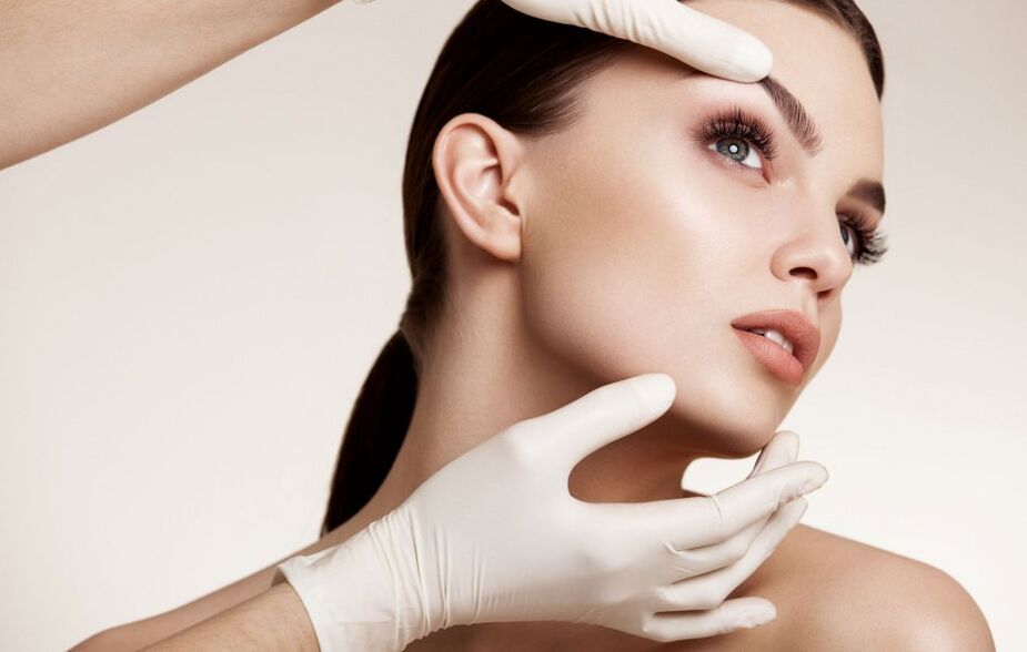 cosmetologist examines facial skin before rejuvenation